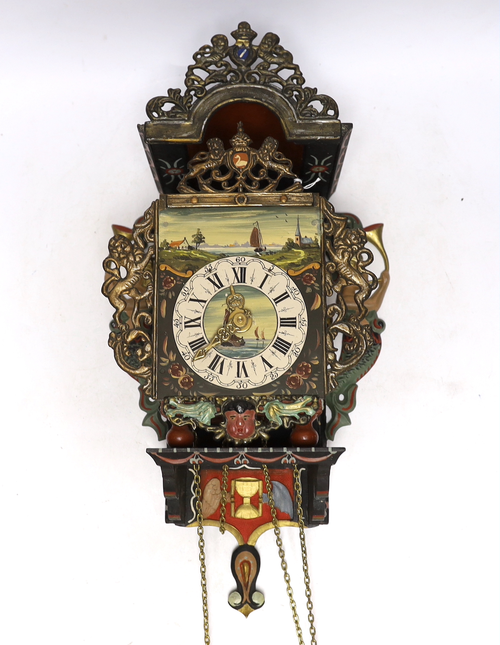 A vintage Dutch clock, hand painted with a landscape and flowers, with pendulum and weights, 53cm high
